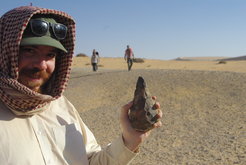 Group Leader Dr Huw Groucutt with a stone tool made by early humans in northern Arabia around 300 thousand years ago, when an abrupt period of climate change transformed the desert into a grassland full of lakes.